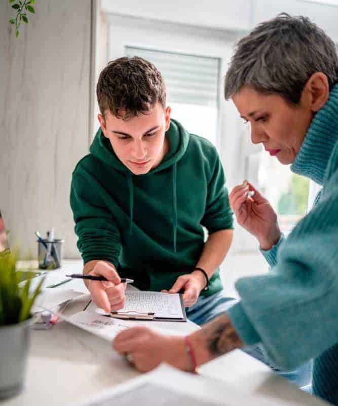 Two people reviewing documents together at a table.