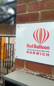 Sign for Red Balloon in Norwich, UK.